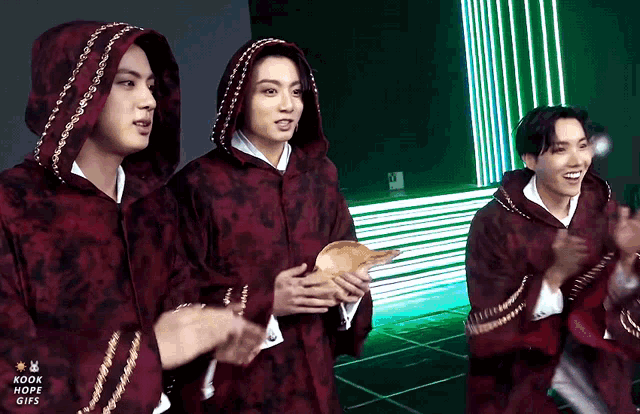 a group of young men are standing next to each other with the words kook hope gifs on the bottom left