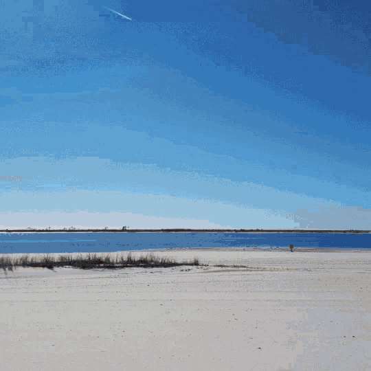 a bridge over a body of water with a car going over it