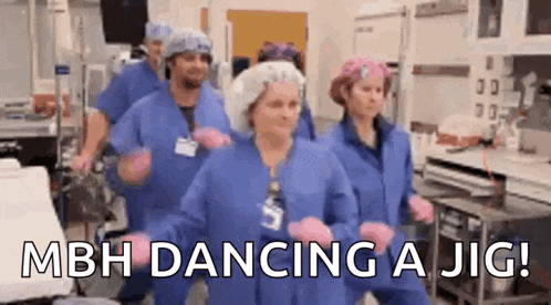 a group of nurses are dancing in an operating room .