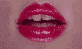 it is a close up of a woman 's lips with red lipstick .
