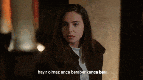 a woman in a dark room with the words hayir olmaz anca beraber kanca bere