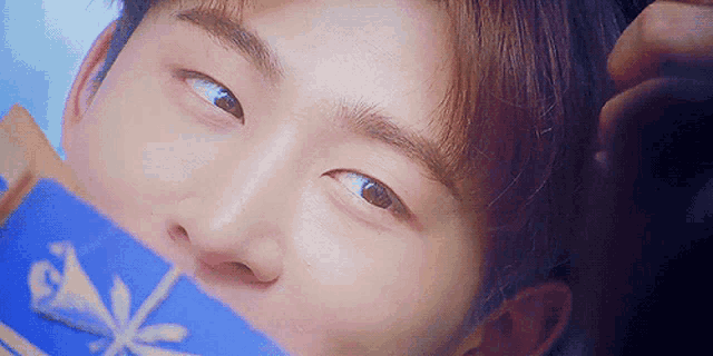 a close up of a person 's face with a blue box in front of it that says ' ice ' on it