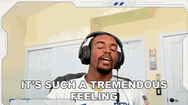 a man wearing headphones with the words it 's such a tremendous feeling behind him