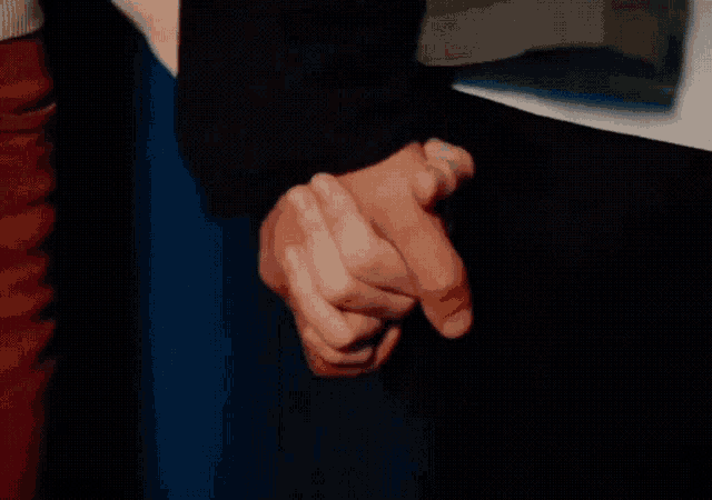a close up of a person holding another person 's hands