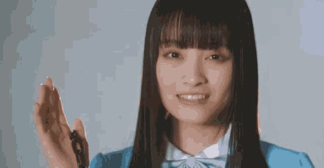 a girl in a blue shirt is holding a key in her hand .