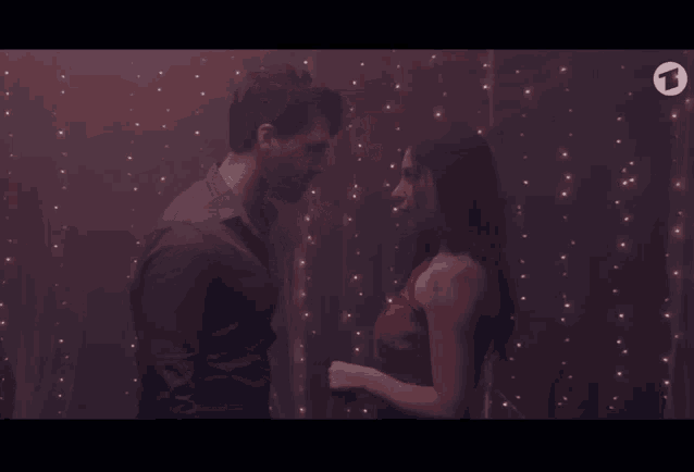 a man and a woman are looking at each other