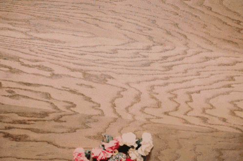 a wooden table with flowers and the word mipil