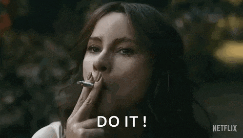 a woman is smoking a cigarette and says `` do it ! ''
