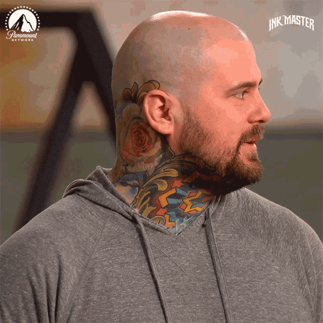 a man with a tattoo on his neck and a paramount network logo