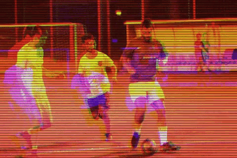 a group of soccer players are playing a game of soccer