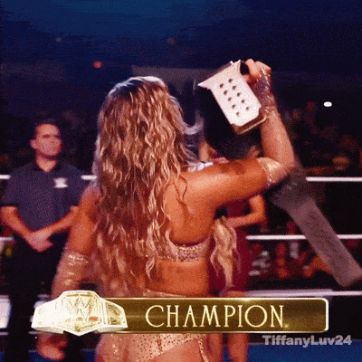 a woman in a wrestling ring with the word champion on the bottom