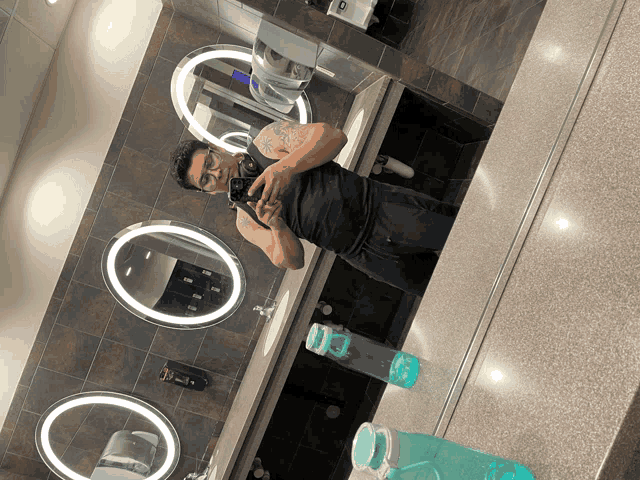 a man is taking a picture of himself in a bathroom