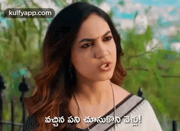 a woman in a saree is making a funny face in a telugu movie .