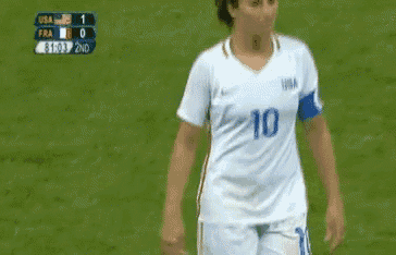 a female soccer player wearing a white jersey with the number 10 on it .