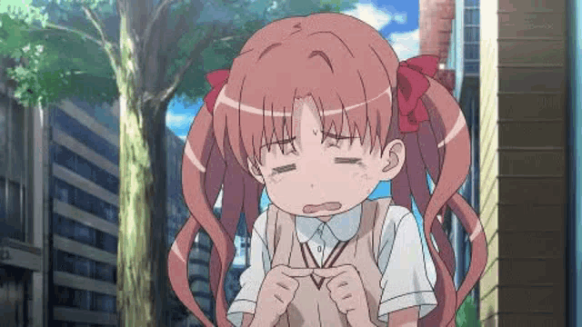a girl with long red hair is making a funny face in front of a building .