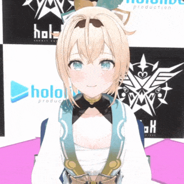 a girl with blonde hair and blue eyes is smiling in front of a hololive production sign
