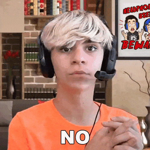 a young man wearing headphones and an orange shirt says " no "