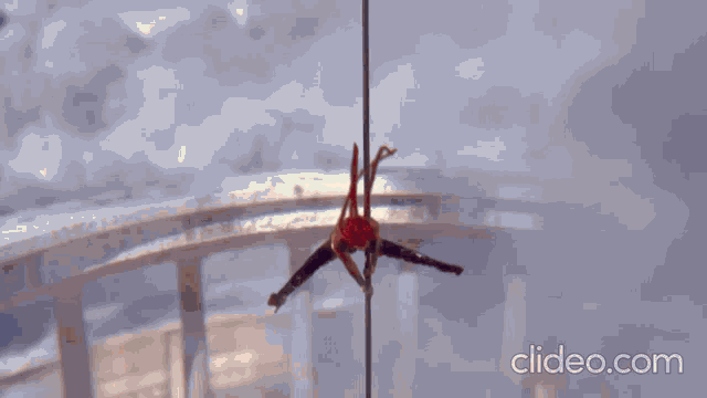 a video of a woman doing aerial acrobatics with clideo.com in the corner