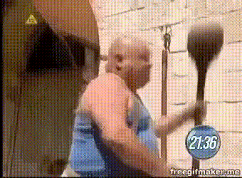 a man in a blue tank top is holding a boxing glove in front of a clock that says 21:36