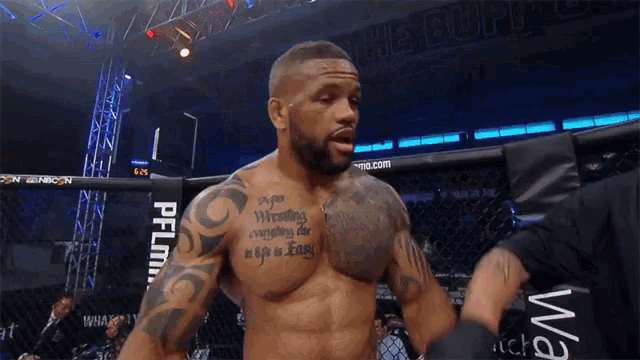a man in a boxing ring has a tattoo on his chest that says " ever wrestling "