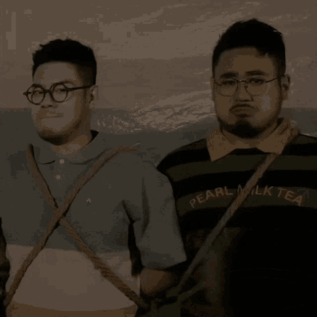 two men wearing glasses and pearl milk tea shirts