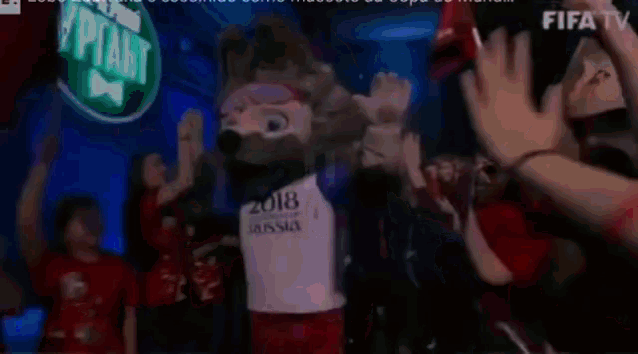 a mascot for the russian soccer team is dancing in front of a crowd .