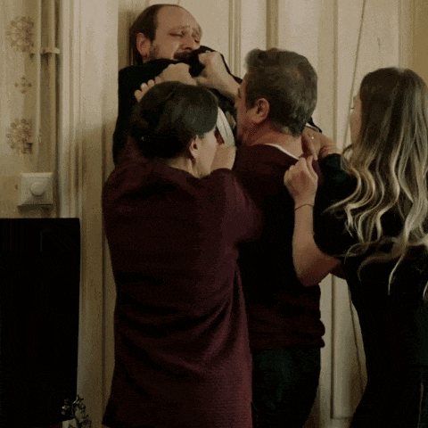 a man is being held by a woman and a woman is holding another man