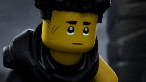 a close up of a lego figure 's face with a sad look on his face