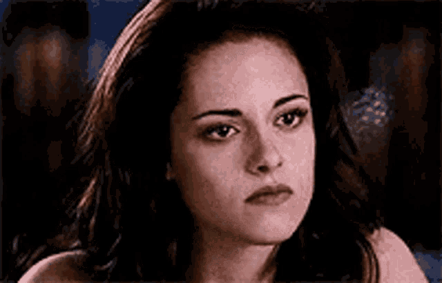 a close up of a woman 's face with a serious expression on her face .