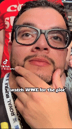 a man with glasses and a royal rumble lanyard on his neck