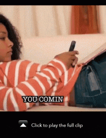 a woman laying on a couch holding a cell phone with the words you comin on the bottom right