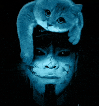 a cat is laying on top of a man 's head with a hat that says fila on it