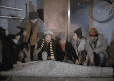 a group of men are looking at a carpet
