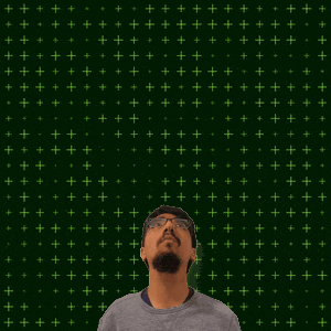 a man stands in front of a green background with the number 11 + 15 on it
