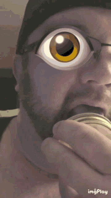 a close up of a man 's face with a cartoon eye and the words imgplay below him
