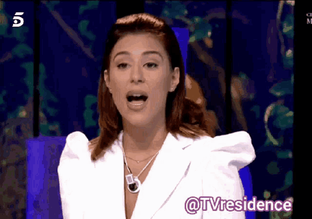 a woman in a white jacket with the words @tvresidence on the bottom left