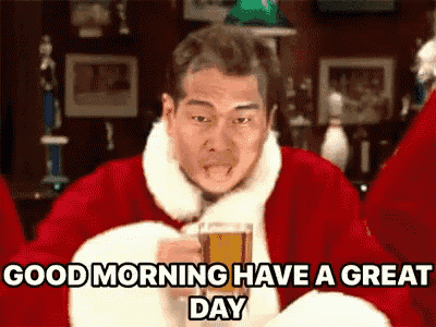 a man in a santa claus costume is holding a glass of beer and saying good morning have a great day .