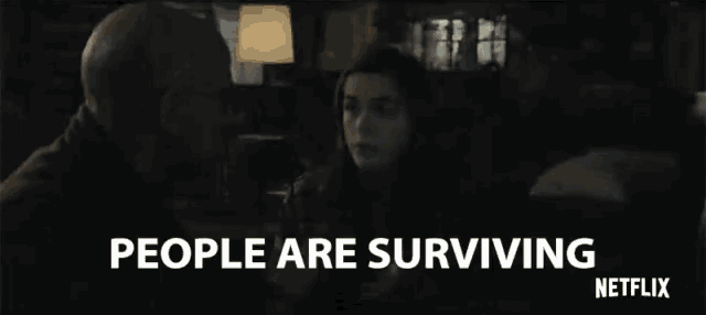 a man and a woman are talking in a dark room with the words people are surviving netflix written on the bottom .