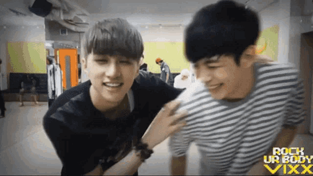 two young men are hugging each other and the words rock ur body vixx are on the bottom