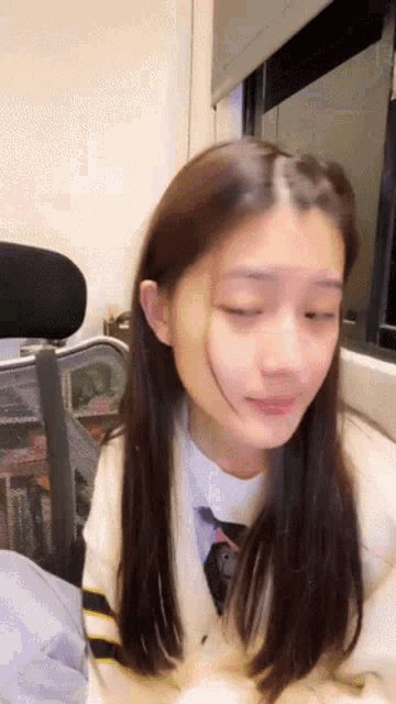 a close up of a girl with her eyes closed