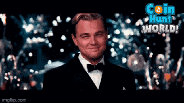 a man in a tuxedo is smiling in front of a coin hunt world advertisement