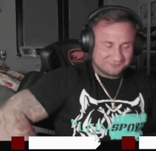a man wearing headphones and a t-shirt that says sport