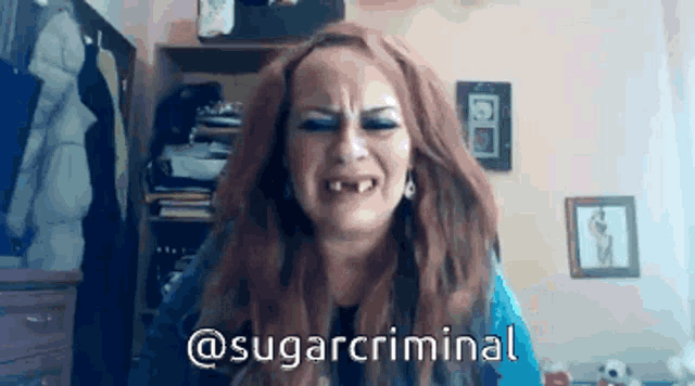 a woman is crying with the words @sugarcriminal written below her