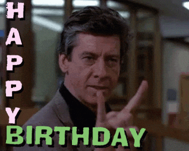 a man is giving a peace sign and the words happy birthday are behind him