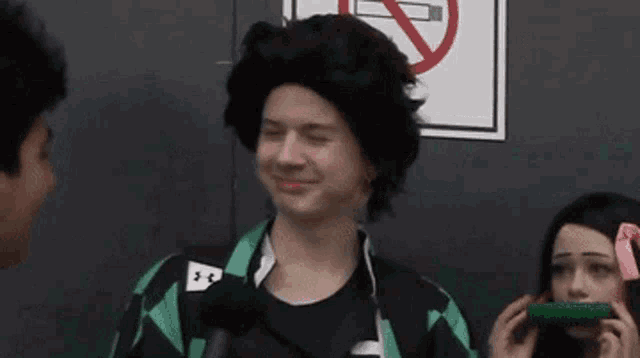 a man in a wig is standing next to a woman in a costume .
