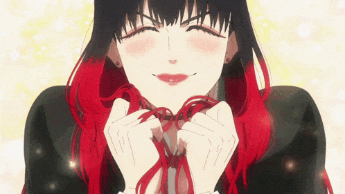 a girl with black and red hair is smiling and holding a red ribbon around her neck