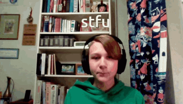 a person wearing headphones with stfu written in white