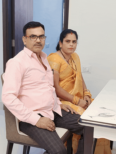 a man and a woman are sitting at a table holding hands