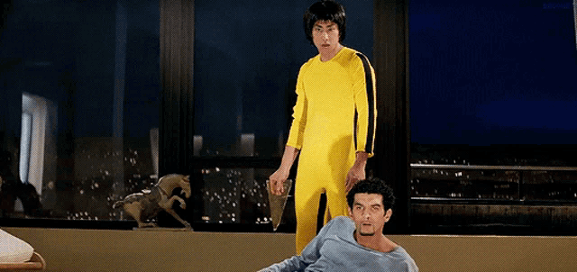 two men in yellow jumpsuits are standing next to each other
