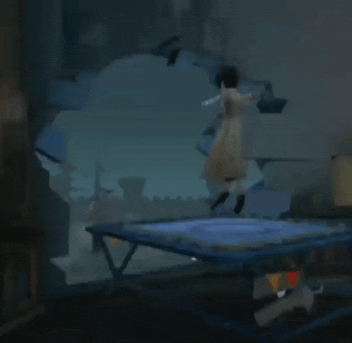 a woman is jumping on a trampoline in a dark room